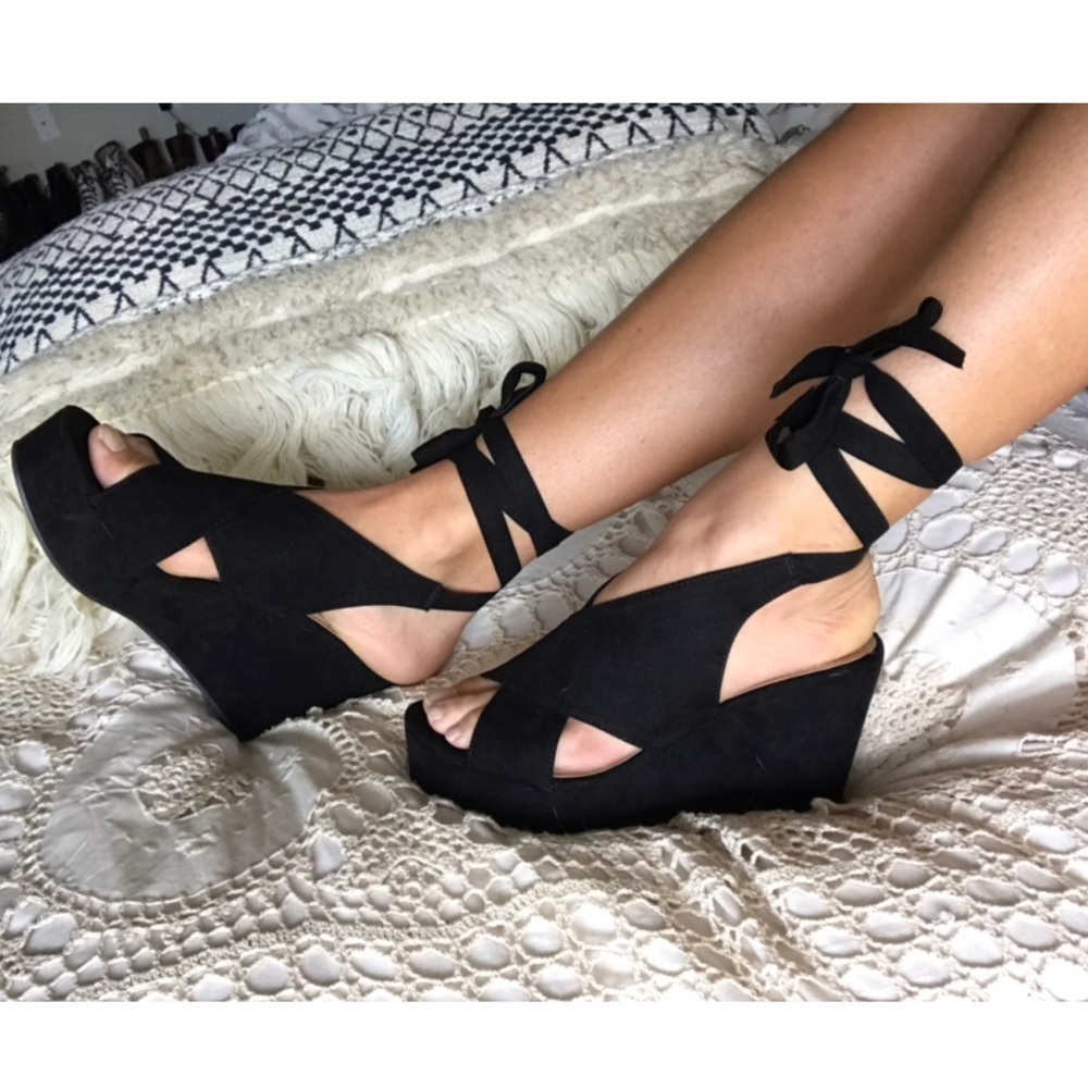 Black strappy wedge heels.